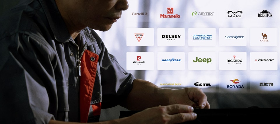 Production specialist at work beside partner brand logos