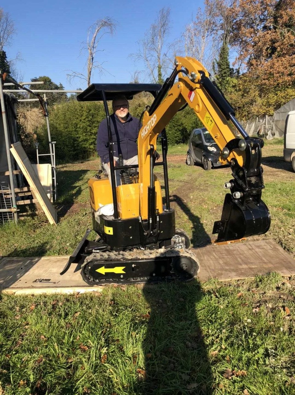 UK Homeowner Sitting on HT10C Mini Excavator in Garden