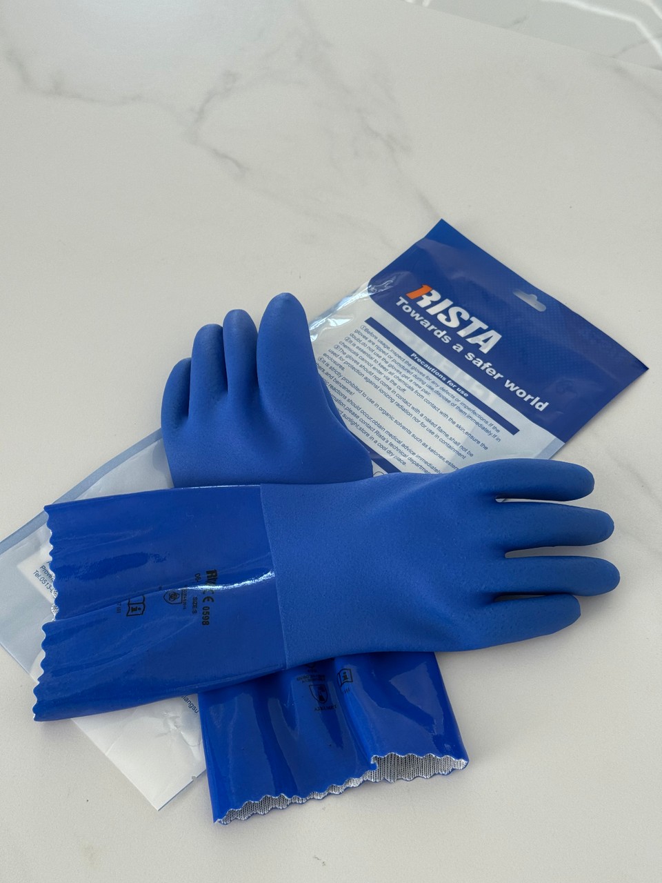 Blue RISTA protective gloves and retail packaging
