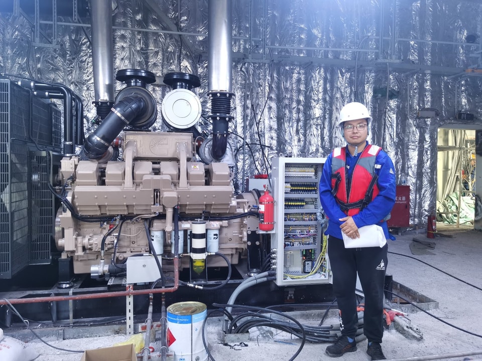 Field engineer supporting an installed diesel generator system