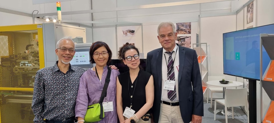 Visitors at the GPPE stand at Labelexpo Americas 2024, with a GPPE machine and display screen behind them