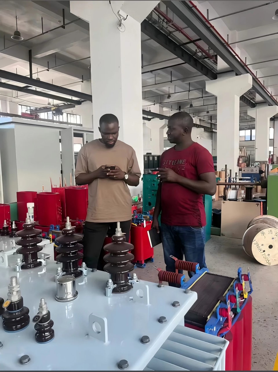 Customers inspecting bushings and components on the production floor